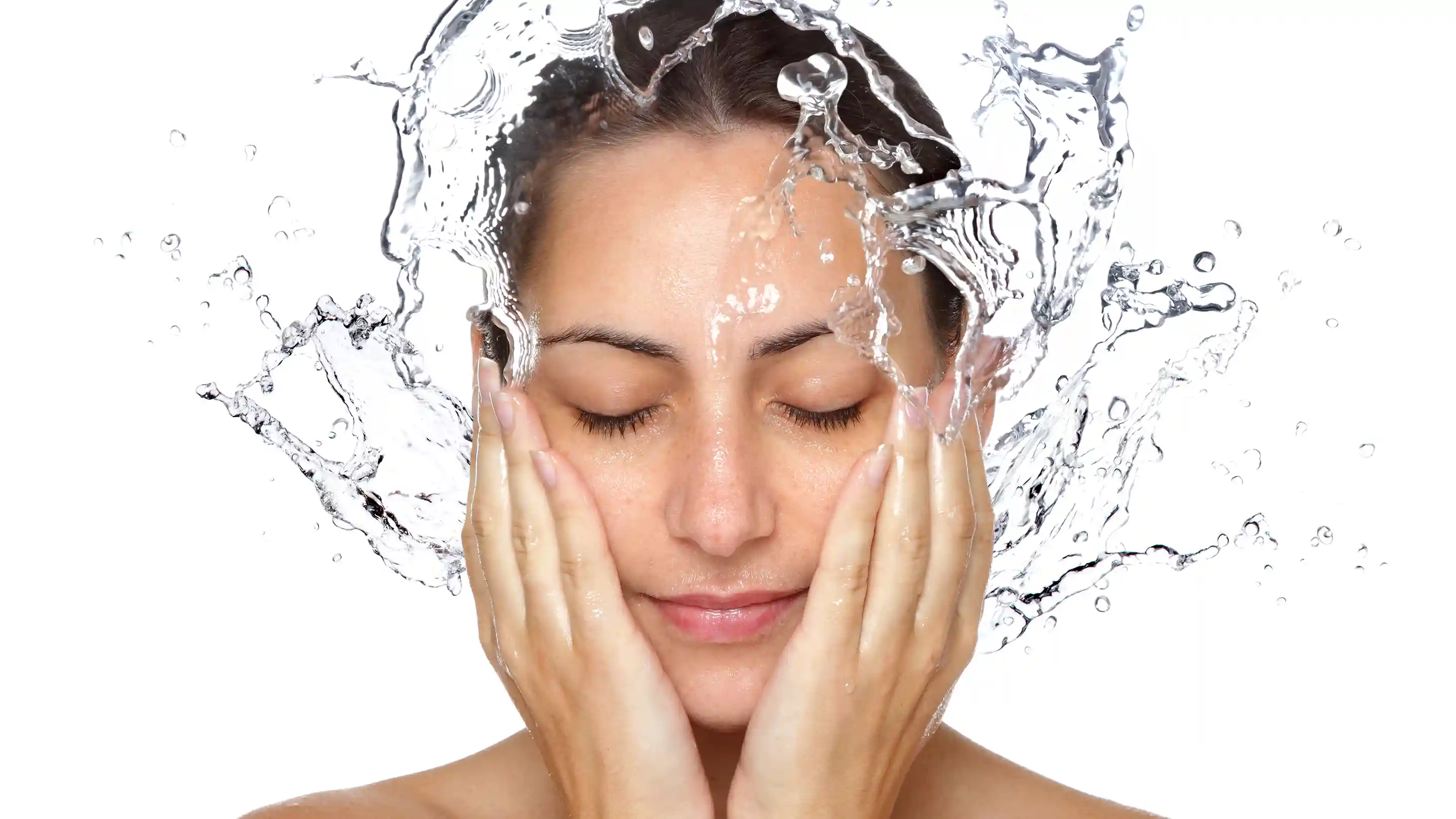 Woman splashing water on her face