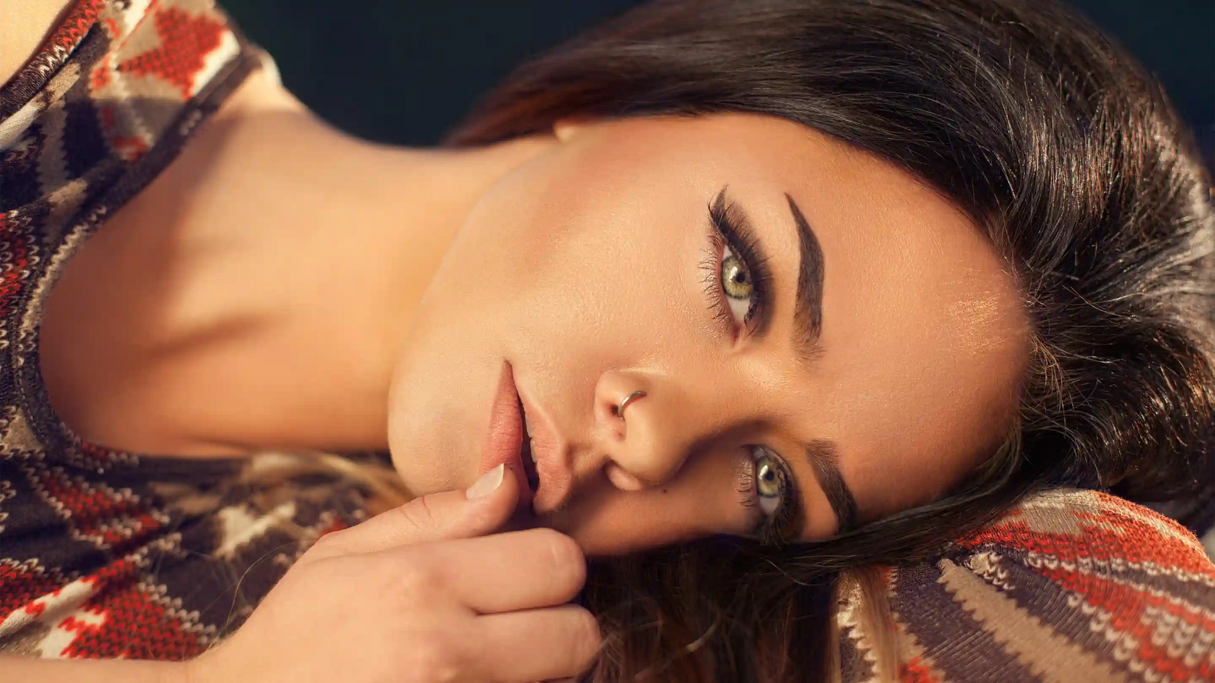 Woman laying down touching her lips