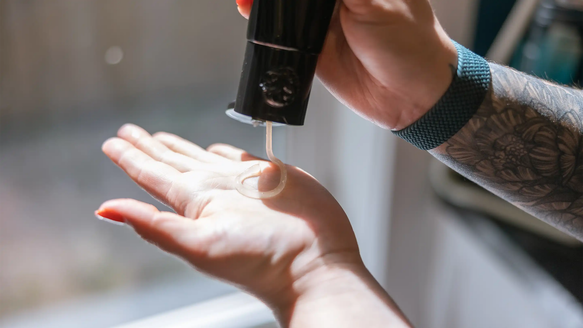 Hair stylist pouring a hair smoothing treatment product into their palm